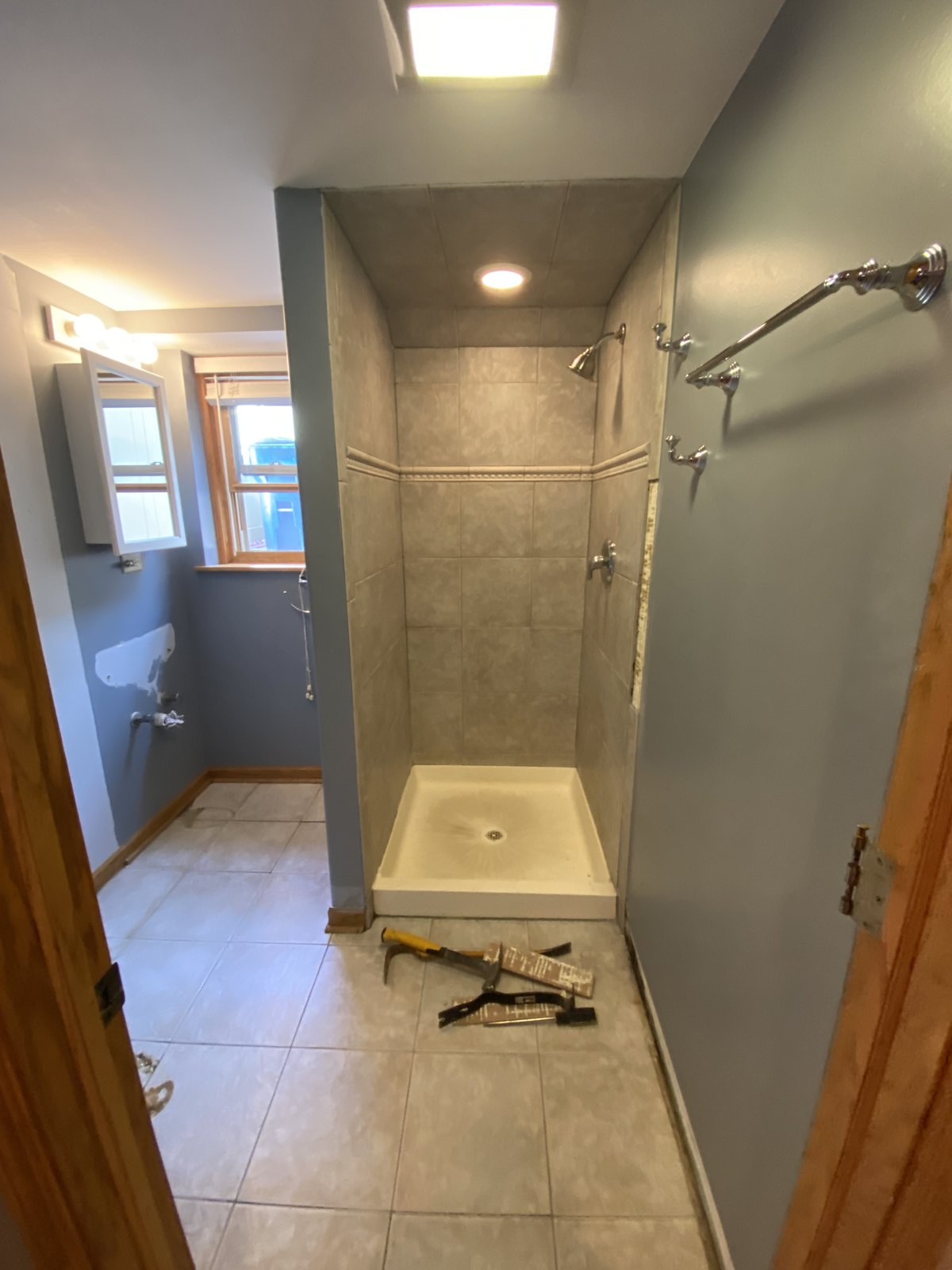 José’s bathroom project before demolition, with tiled shower and floor